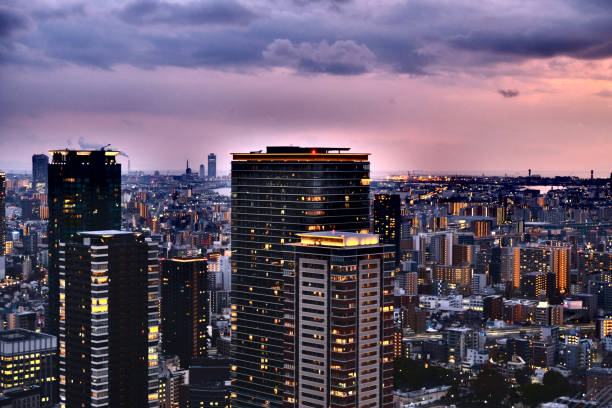 Lighten Osaka cityscape at dusk, viewed from the Umeda Sky Building, a two-tower landmark skyscraper height 170 mt, located in the outskirts of Umeda business district in Kita-ku, Osaka.
