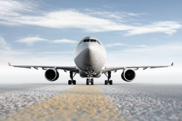 istock Front view of wide body passenger aircraft isolated on bright background with sky 2159225721