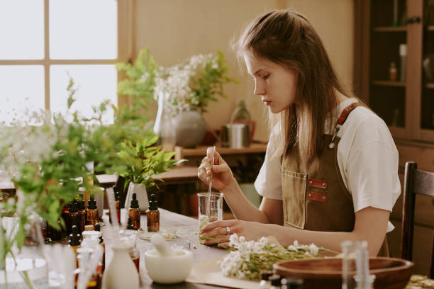 istock Female Intern Mixing Liquid with Dried Petals 2159226925