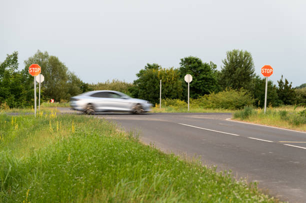 istock Stop and give way traffic signs with a car passing by 2159227640