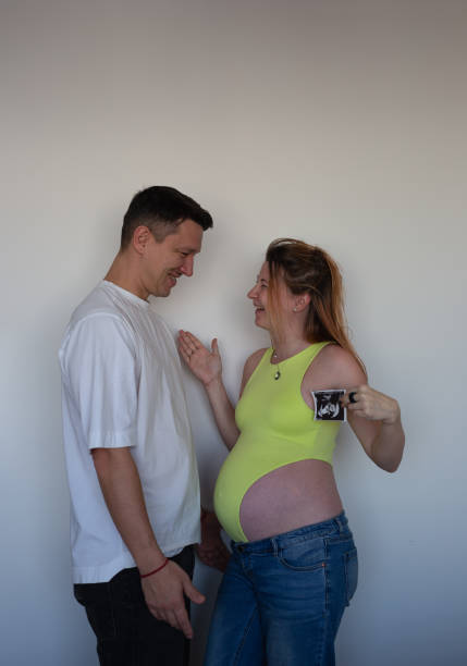 Expecting parents eagerly await their baby's arrival, holding the first ultrasound.