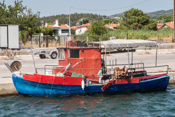Old vintage fishing boat in Mediterranean port on sunny summer day