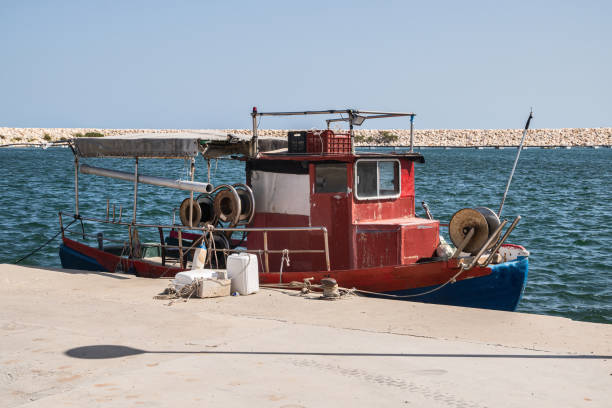 Old vintage fishing boat in Mediterranean port on sunny summer day