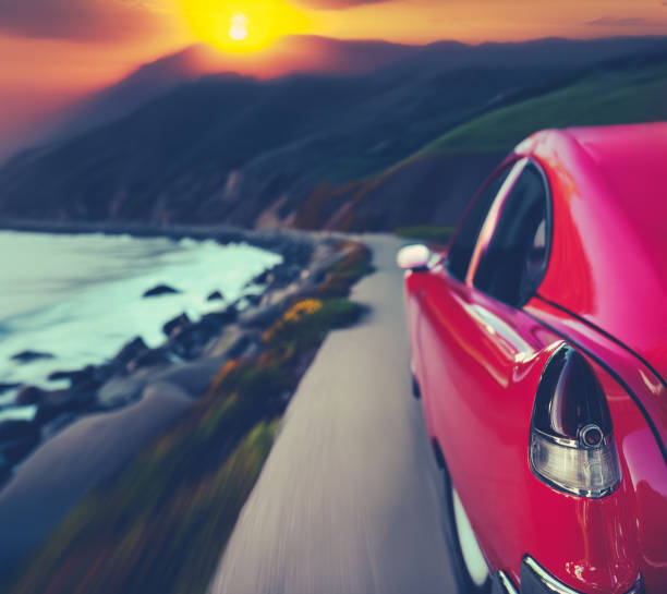 Stylized Image Of A Classic Red American Car Driving On The Big Sur Coast Highway In California At Sunset