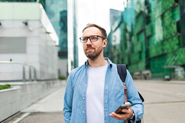 istock Mid adult man using mobile at the street 2159231272