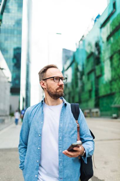 istock Mid adult man using mobile at the street 2159232745