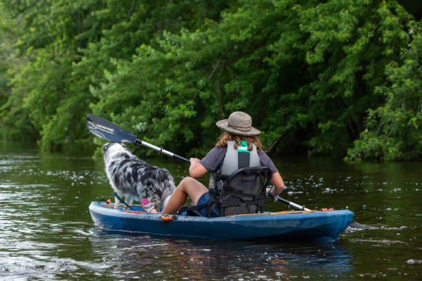 istock Girl Kayaking Down A River With Her Dog 2159232766