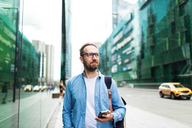 istock Mid adult man using mobile at the street 2159234738