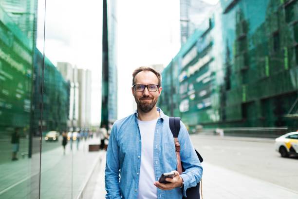 istock Mid adult man using mobile at the street 2159234974