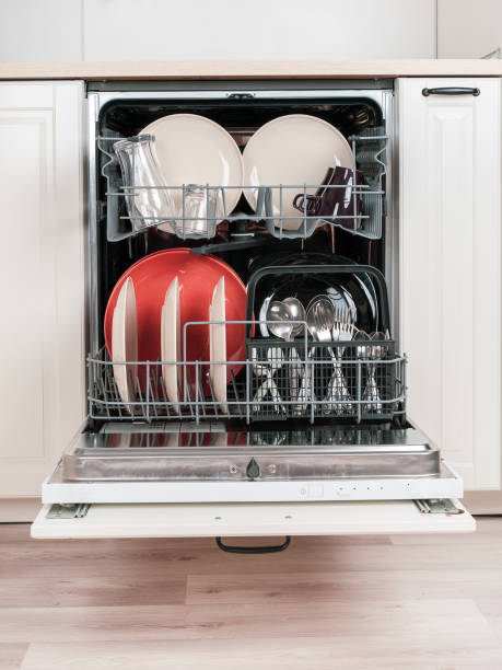 istock Modern dishwasher built into the kitchen unit for washing dishes 2159236391