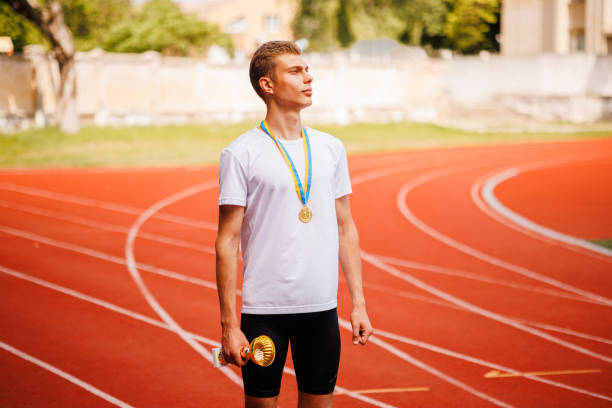 istock A track runner is standing at the starting line, getting ready for a quick sprint 2159236427