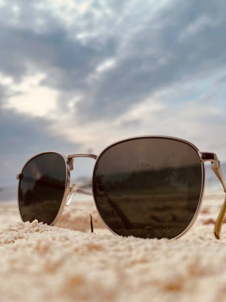 istock Eyewear placed on the sand at the beach. 2159238842