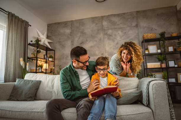 istock Proud parent of their son who learn to read, sit and read a book 2159238930