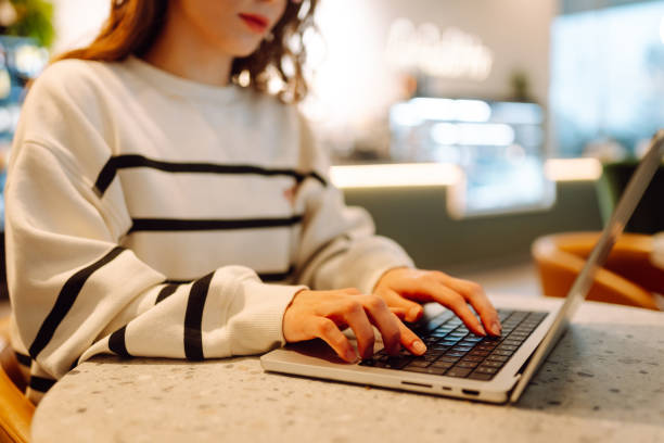 istock Close-up of hands working on a laptop keyboard. 2159240179