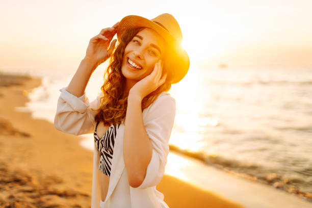 istock Happy woman walking at a beach at sunset. 2159240808