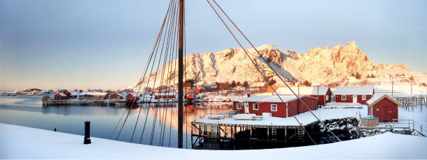 Ballstad, Lofoten archipelago, Norway: sunrise on the village of Ballstad, in Vestvågøy Municipality of the Lofoten Isles. It is one of the largest fishing villages in Lofoten, in the background, mount Skottinden.