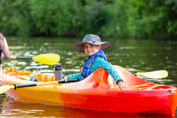 istock Boy In Orange & Yellow Kayak on Summer Evening 2159245558