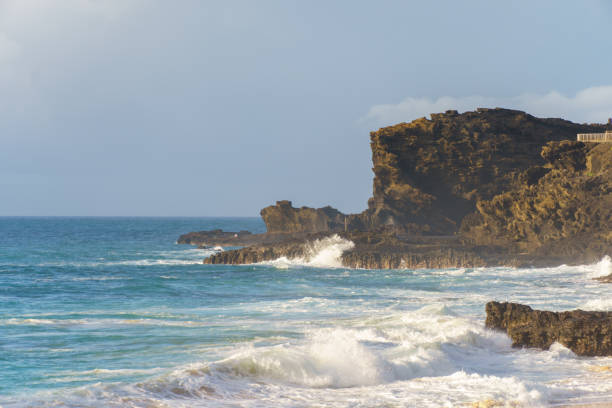 istock A blurry image of a beach with waves crashing on rocks under the sky 2159248279