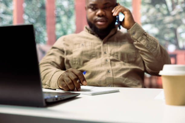 Administrator discussing with shareholders on phone call to increase funding for expansion and development. Man working from home and calling investors to share annual reports.