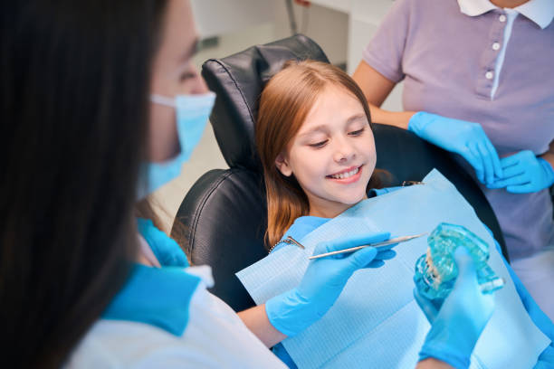 istock Dental hygienist communicates during consultation with a young patient 2159249208