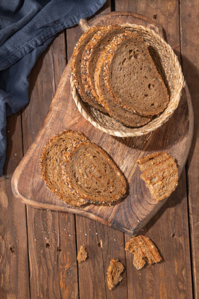 istock Whole Grain rye bread with seeds on a wooden board. Top view 2159250657