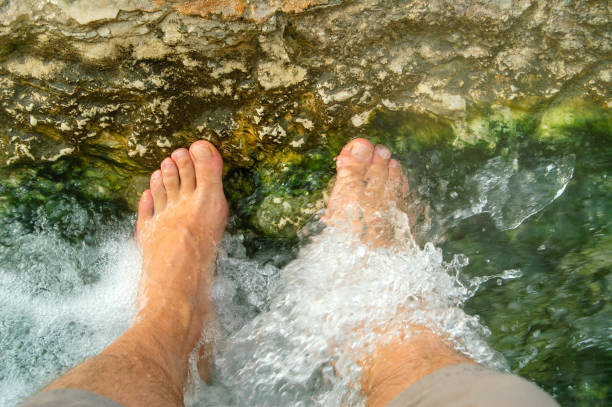 istock refreshing foot bath in a small canal with hot spring water 2159252320