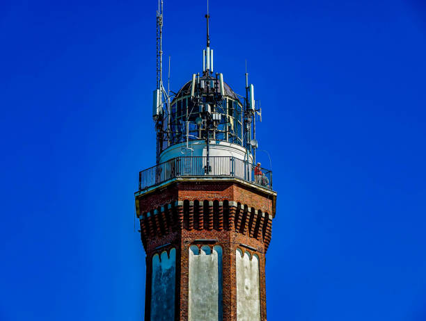 istock A tall tower with a red brick base and a white top 2159252759