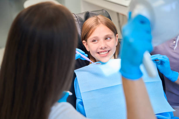 istock Smiling girl communicates with a dentist in the office 2159253053