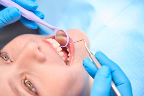 istock Smiling girl in a dentists chair 2159253082