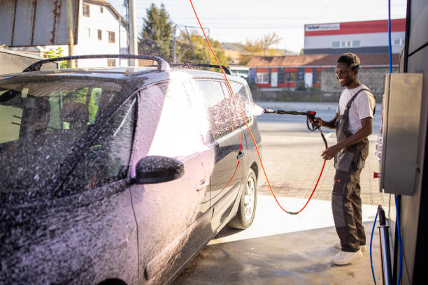 istock Worker Washing Car at Outdoor Service Station 2159258074