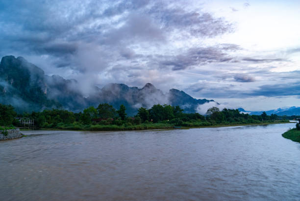 Vang Vieng, Laos: Picturesque landscapes featuring lush greenery, karst limestone mountains, and serene rivers. Known for its vibrant party scene, this popular tourist destination offers activities such as tubing down the Nam Song River, kayaking, hiking, and exploring caves. Visitors often enjoy the lively bars and social atmosphere, making it a hub for adventure and nightlife.