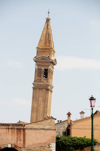 Burano, Venice, Italy, June, 26, 2023: Exterior of the famous leaning bell tower of Burano, an island in the Ventian Lagoon, northern Italy, known for its lace work.