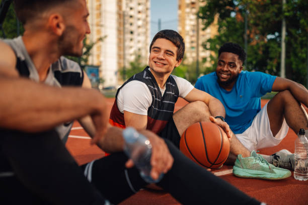 istock Men on basketball court sharing a light moment 2159261496