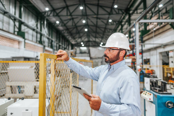 Industrial engineer checking installation in regulatory standard 12 Brazil - NR 12