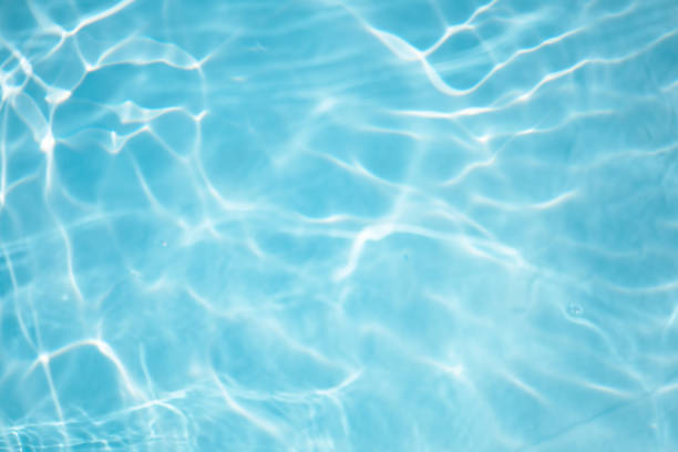 istock Blue water with ripples on the surface. Defocus blurred transparent blue colored clear calm water surface texture with splashes and bubbles. Water waves with shining pattern texture background. 2159267989