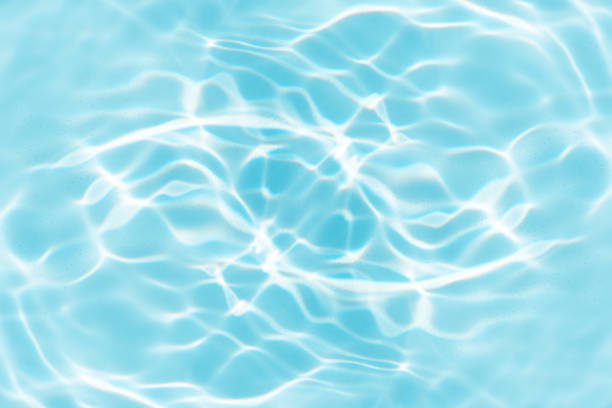 istock Blue water with ripples on the surface. Defocus blurred transparent blue colored clear calm water surface texture with splashes and bubbles. Water waves with shining pattern texture background. 2159268004