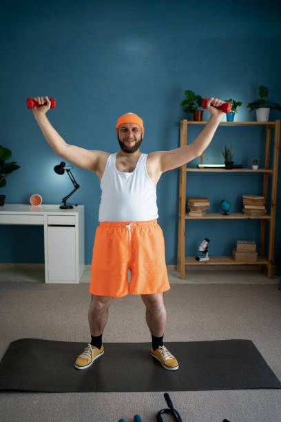 istock Man lifting dumbbells during home workout, focusing on upper body strength. 2159268647