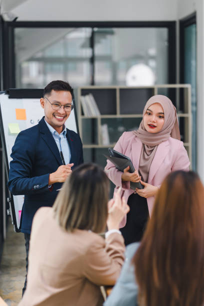istock Professional diverse business team presenting and discussing data charts and graphs during meeting in modern office. 2159268656