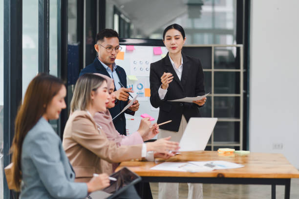 istock Professional diverse business team presenting and discussing data charts and graphs during meeting in modern office. 2159268673