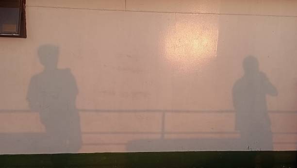istock The shadows of two men on the wall 2159271905