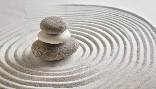 istock Zen garden with the stones and white sand pattern minimal scene Stack of Balanced Pebbles, zen pebbles, relax, massage, meditation, studio photography 2159278073