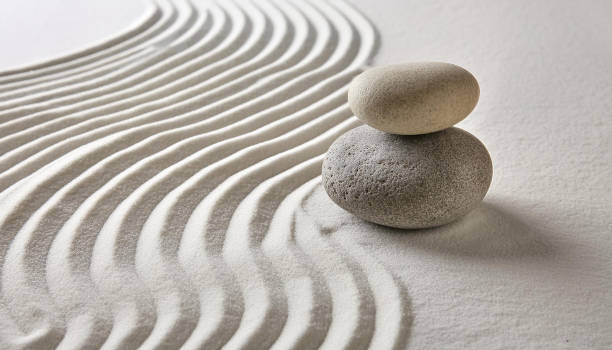 istock Zen garden with the stones and white sand pattern minimal scene Stack of Balanced Pebbles, zen pebbles, relax, massage, meditation, studio photography 2159278075
