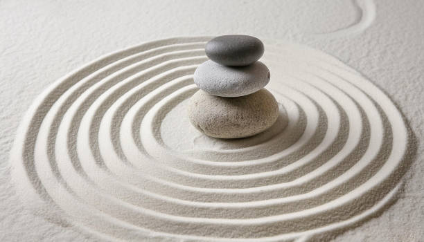 istock Zen garden with the stones and white sand pattern minimal scene Stack of Balanced Pebbles, zen pebbles, relax, massage, meditation, studio photography 2159278077