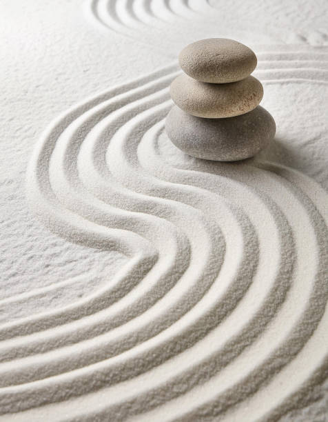 istock Zen garden with the stones and white sand pattern minimal scene Stack of Balanced Pebbles, zen pebbles, relax, massage, meditation, studio photography 2159278078