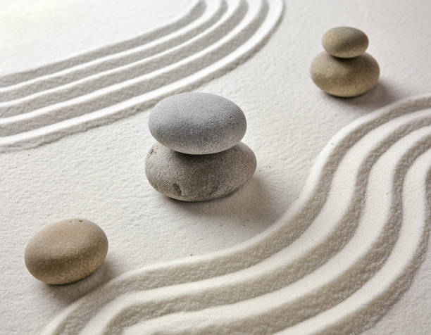 istock Zen garden with the stones and white sand pattern minimal scene Stack of Balanced Pebbles, zen pebbles, relax, massage, meditation, studio photography 2159278079