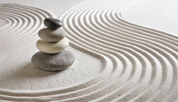 istock Zen garden with the stones and white sand pattern minimal scene Stack of Balanced Pebbles, zen pebbles, relax, massage, meditation, studio photography 2159278080