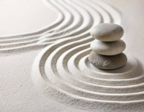 istock Zen garden with the stones and white sand pattern minimal scene Stack of Balanced Pebbles, zen pebbles, relax, massage, meditation, studio photography 2159278084