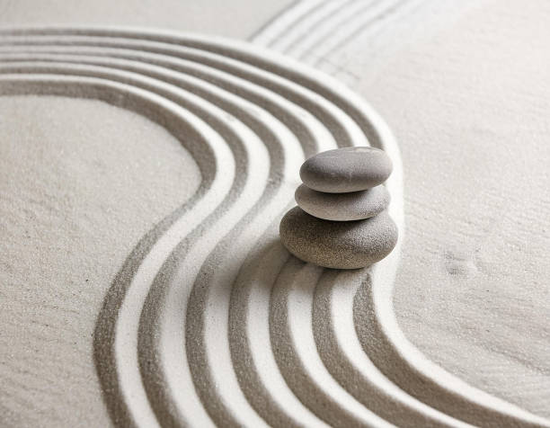 istock Zen garden with the stones and white sand pattern minimal scene Stack of Balanced Pebbles, zen pebbles, relax, massage, meditation, studio photography 2159278086