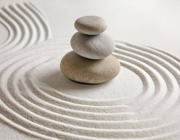 istock Zen garden with the stones and white sand pattern minimal scene Stack of Balanced Pebbles, zen pebbles, relax, massage, meditation, studio photography 2159278087