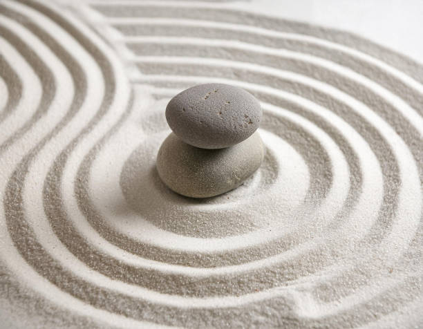istock Zen garden with the stones and white sand pattern minimal scene Stack of Balanced Pebbles, zen pebbles, relax, massage, meditation, studio photography 2159278089